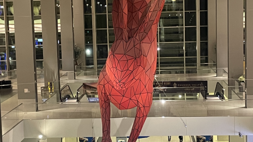 Sculpture of a red rabbit titled "Leap" by Lawrence Argent in Sacramento International Airport's Terminal B