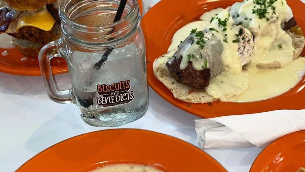 A table with biscuits and gravy and other dishes at Biscuits and Benedicts